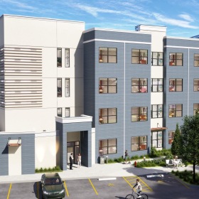 a building entrance with a parking lot