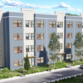 a large white building with trees and a road in front of it